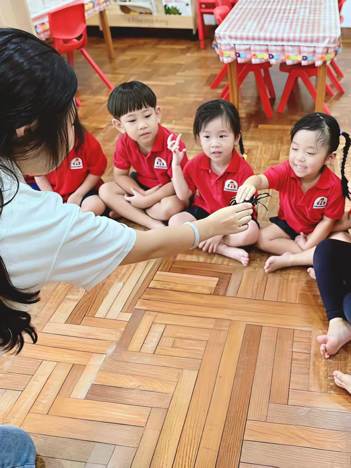Teacher leading a group lesson for preschool children at MapleBear Jurong West bilingual classroom