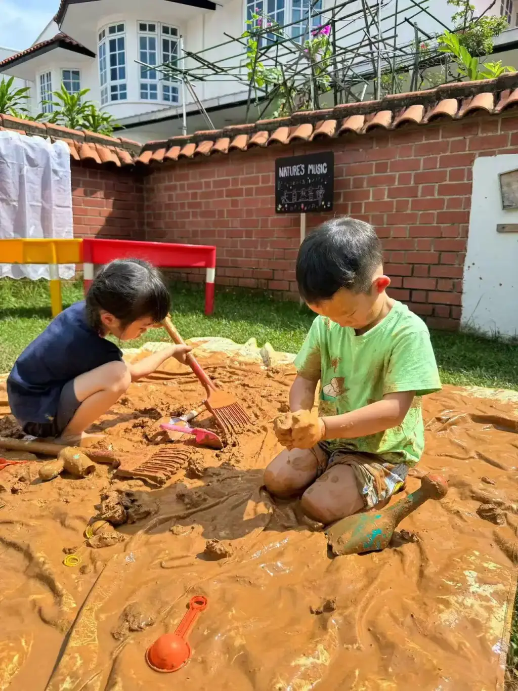 Preschool children exploring nature at the outdoor playground of MapleBear Jurong West