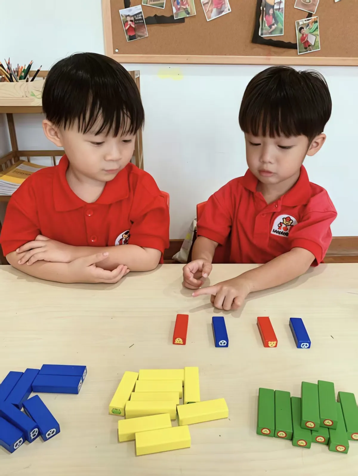 Children learning numeracy and counting with colour-coded math blocks at MapleBear Jurong West Canadian curriculum preschool
